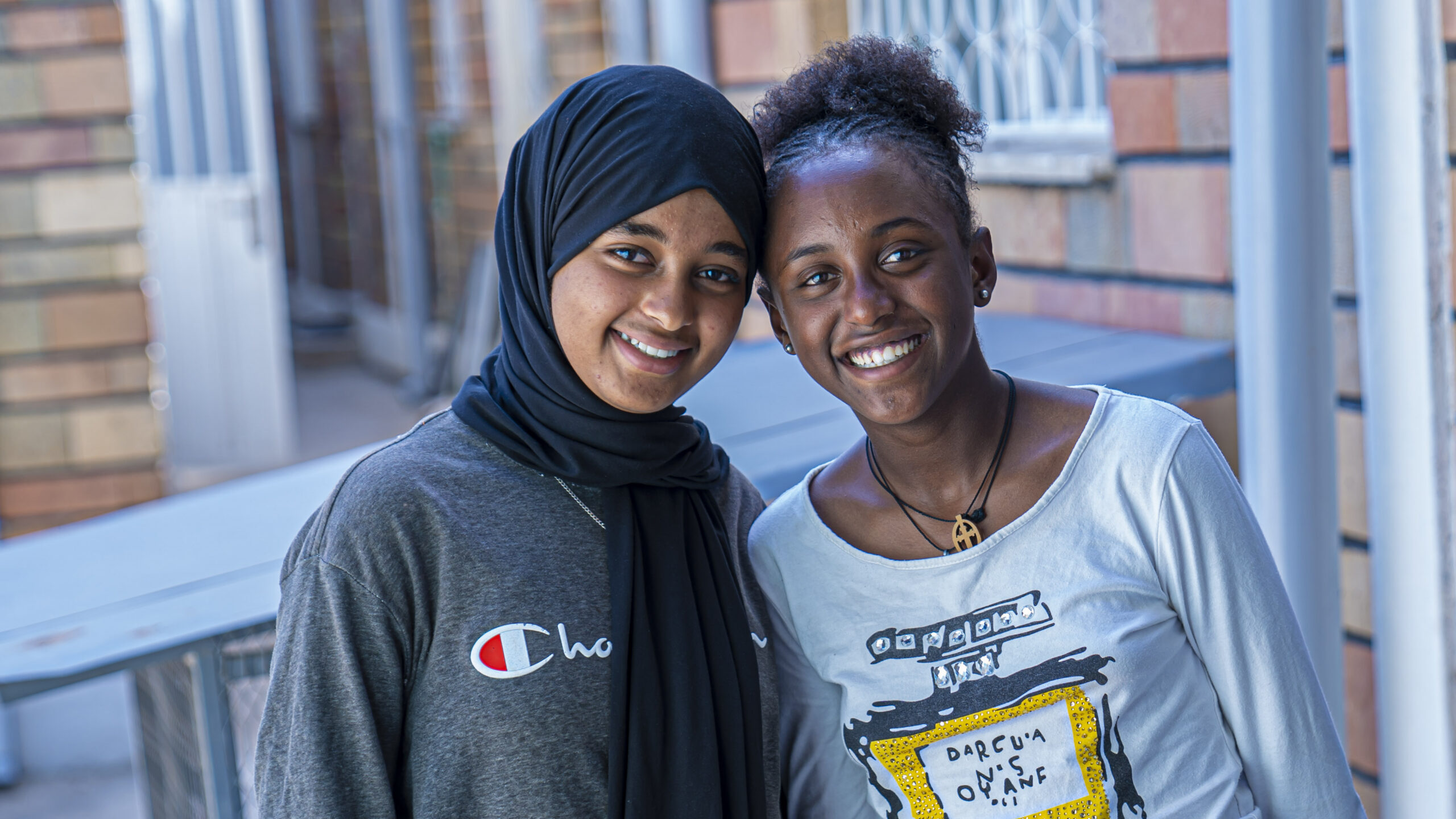 Two young Ethiopian students smiling confidently while preparing for their national exams through the LCE Child Enrichment program.