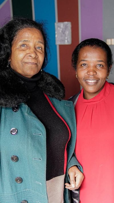 Mulu stands with Mulsh, from the Widow Empowerment Program, a business owner through the interest-free microloan program.