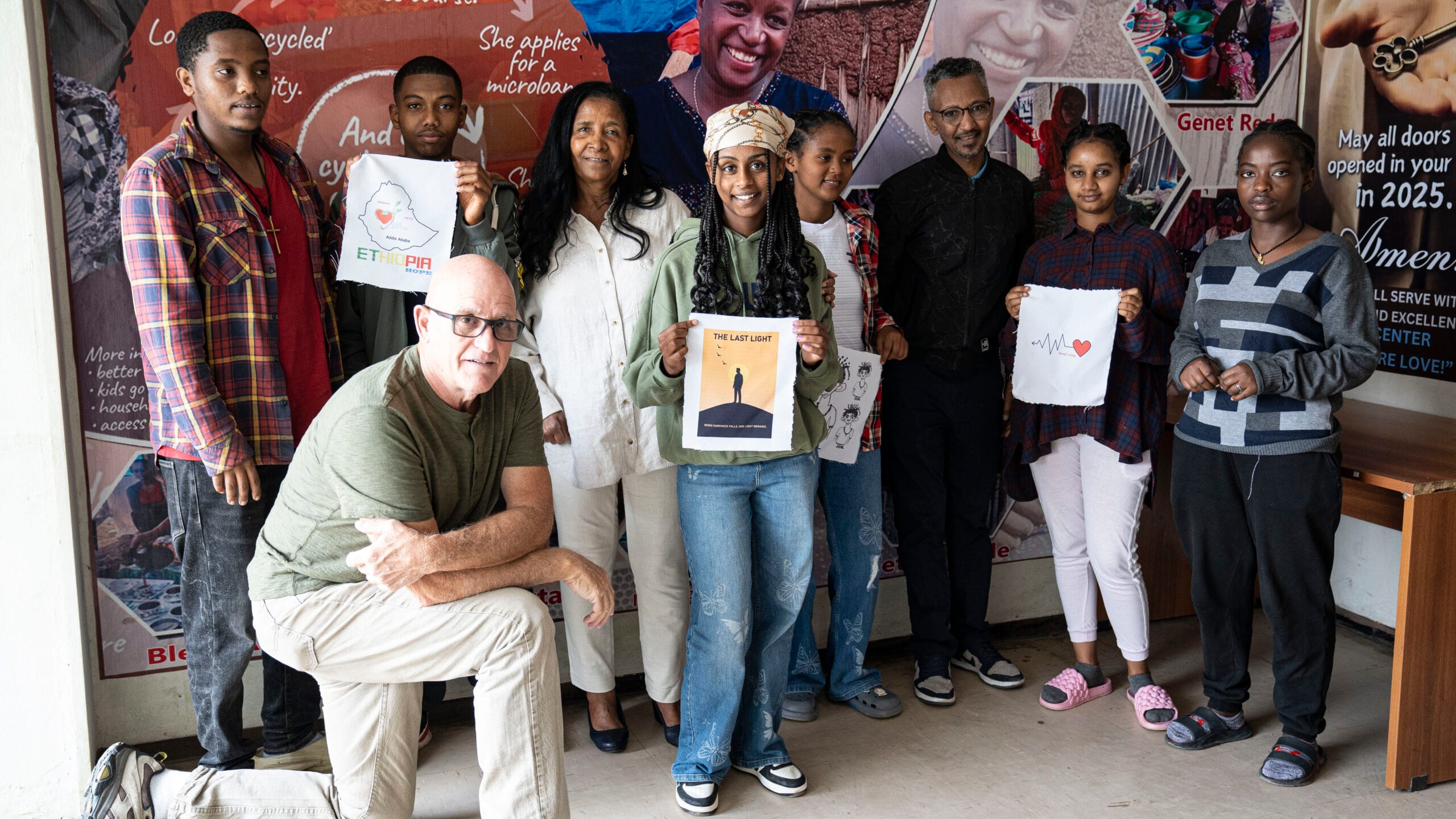 Young Ethiopian entrepreneurs proudly displaying their custom-printed fabric designs during a Collaborative Ventures vocational training workshop.